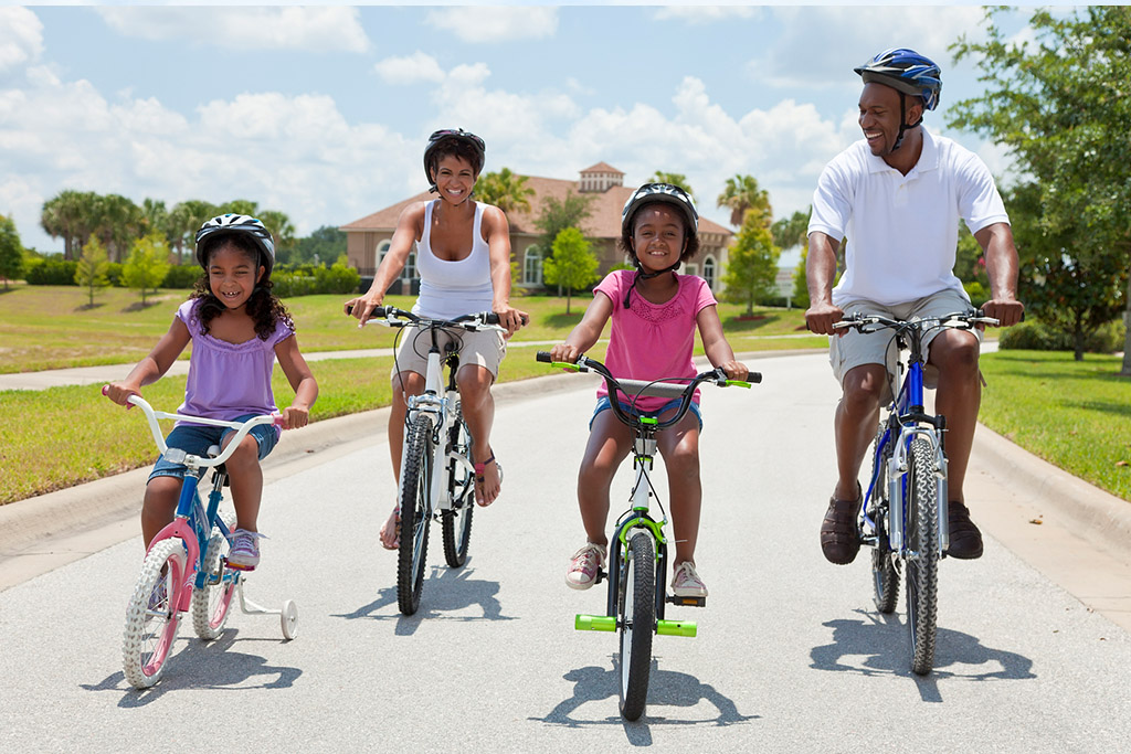 typical-suburban-family-riding-bicycles-in-the-park